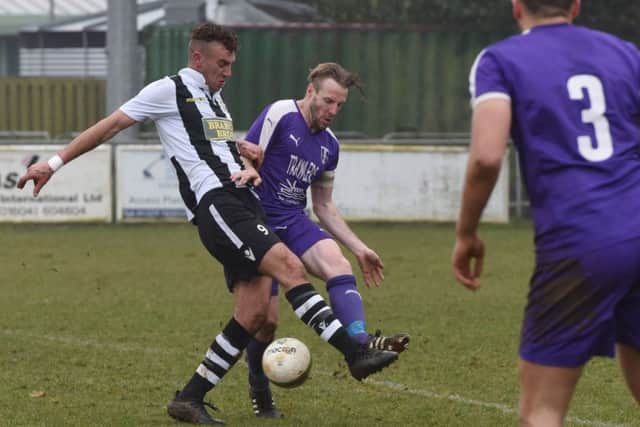 Jake Mason (stripes) of Peterborough Northern Star in action against Daventry Town. Photo: Chantelle McDonald. @Cmcdphotos