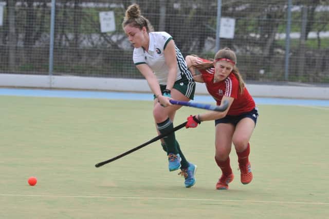 Action from City of Peterborough Ladies (red) against Canterbury at Bretton Gate. Photo: David Lowndes.