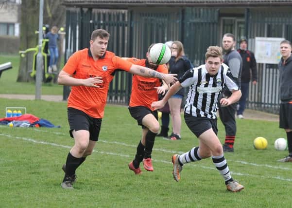 Action from the PFA Junior Cup semi-final between Brotherhood Sports and Oundle Town Reserves (stripes). Photo: David Lowndes.