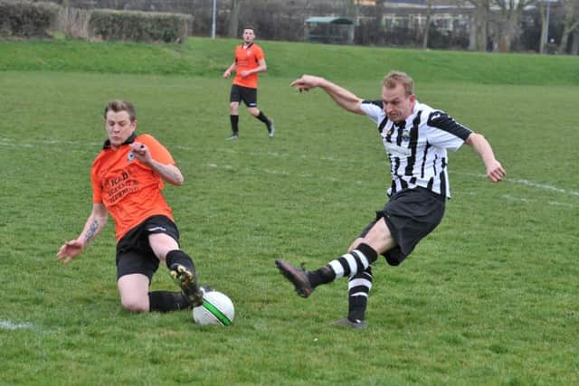 Action from Brotherhood Sports and Oundle Town Reserves (stripes). Photo: David Lowndes.