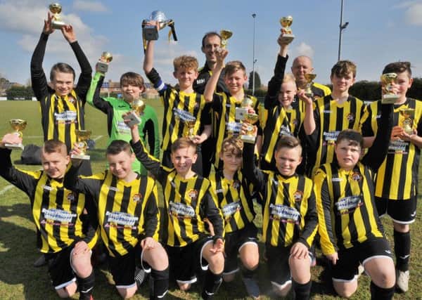 Holbeach United Reds Under 12s celebrate their cup win.
