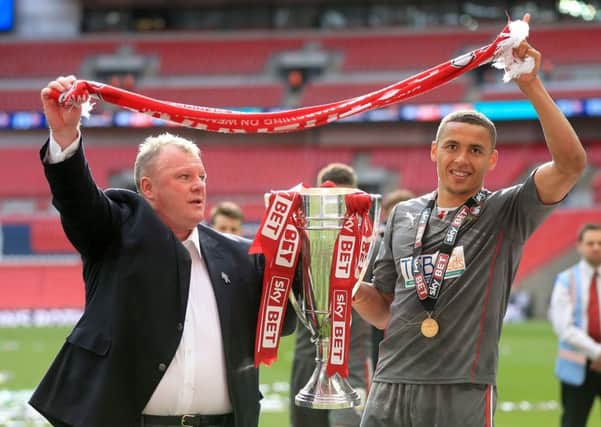 Steve Evans (left) celebrates with player James Tavernier after Rotherham United's League One play-off final win at Wembley in 2014.