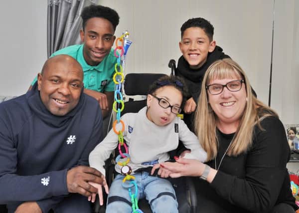 Former Posh player Trevor Quow with wife Michelle, son Dion (11) and nephew Lequahn Quow (15) and Jada-Lea who is in need of special equipment to help with her illness. EMN-180326-214814009
