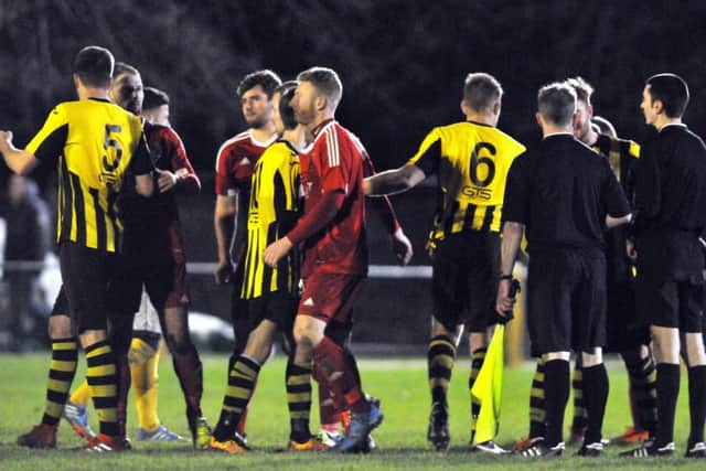 Holbeach United and Wisbech Town (red) clash at Carter's Park on Monday.