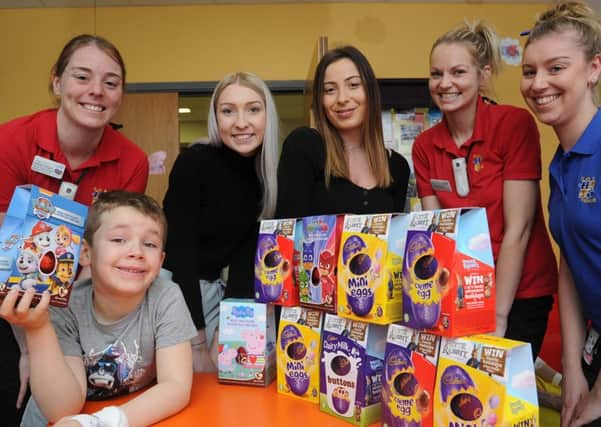 Charlotte Batty and Chantelle Freshwater from  Unique Employment Service with City Hospital Amazon Ward staff Nicola Wright, Chelsea Perry and Hannah Smith with one of the ward's young patients  Harry Cartwright receiving easter eggs from Unique EMN-180327-155917009