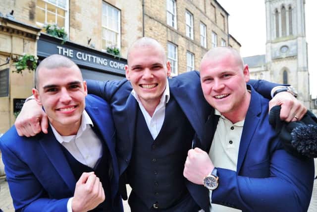 James Willis, a cancer patient  with his brothers Marcus  Willis and   Zak Burrows,  , having their  heads shaved for charity at the Cutting Edge hair salon, Stamford. EMN-180322-213520009