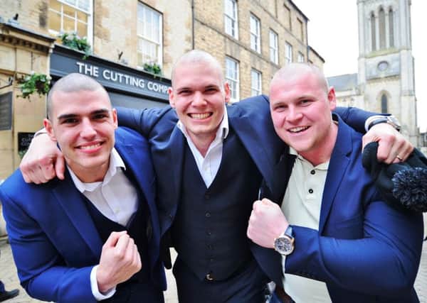 James Willis, a cancer patient  with his brothers Marcus  Willis and   Zak Burrows,  , having their  heads shaved for charity at the Cutting Edge hair salon, Stamford. EMN-180322-213520009