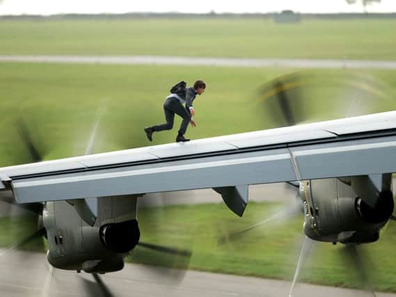 Tom Cruise ran along the wing of an A400 airplane before it took off from RAF Wittering in Mission: Impossible Rogue Nation. Photo: Christian Black, Paramount Pictures EMN-150323-154849001