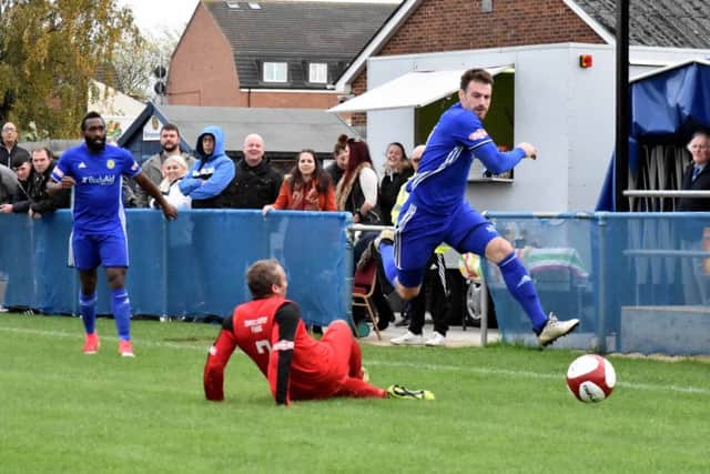 Josh Moreman (blue) scored for Peterborough Sports at Carlton.