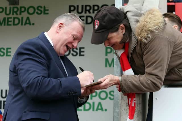 Posh boss Steve Evans signs an autograph before the draw at Rotherham. Photo: Joe Dent/theposh.com.