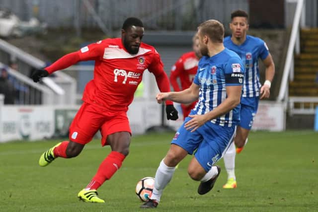 Jordan Smith (red) scored for Stamford AFC against Chasetown.