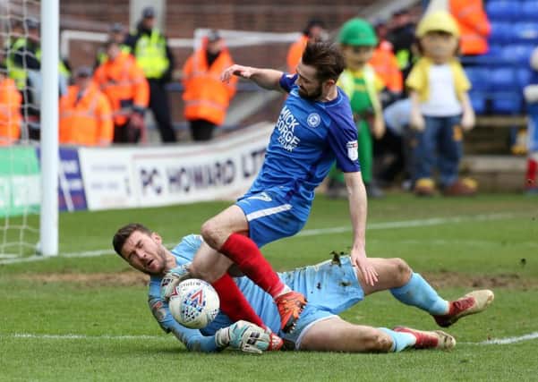 Posh star Gwion Edwards challenges Cobblers' keeper Richard O'Donnell. Photo: Joe Dent/theposh.com.