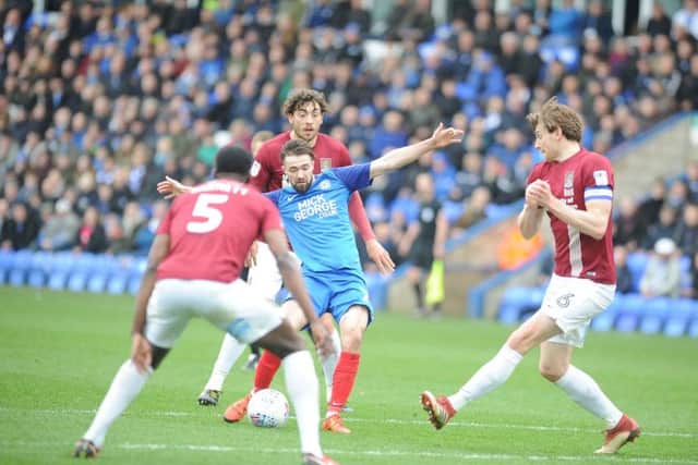 Posh midfielder Gwion Edwards shoots at the Cobblers' goal. Photo: David Lowndes.