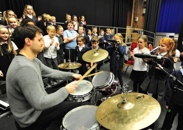 ABBA Schools Singing Day at the  Cresset. Gunthorpe primary school pupils learning about drumming EMN-180603-084302009
