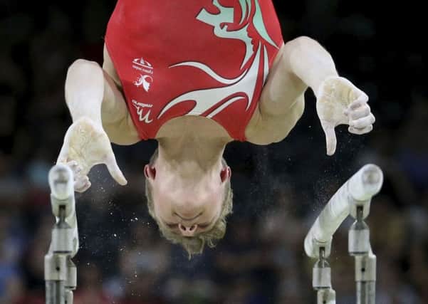 Wales' Benjamin Eyre competes on the parallel bars at the men's artistic gymnastics competition at Coomera Indoor Stadium during the Commonwealth Games on the Gold Coast, Australia.Picture: AP Photo/Dita Alangkara