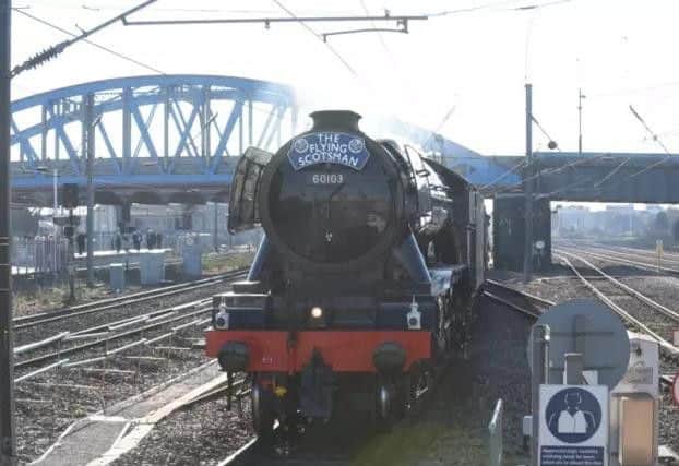 The Flying Scotsman with Peterborough's Crescent Bridge in the background