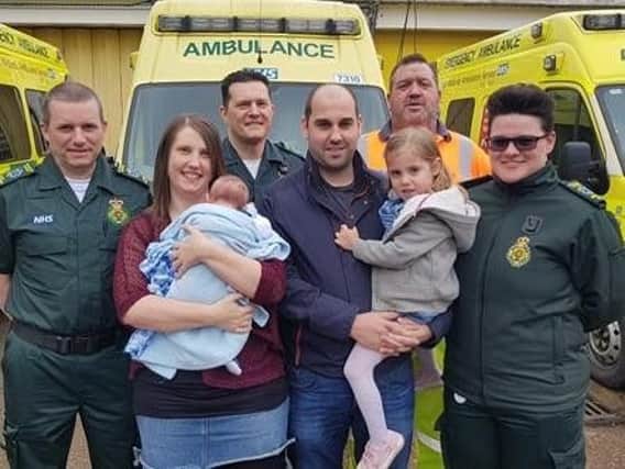 Left to right- Technician Phil Lane, Mum Sarah holding baby Arlo, Paramedic James, Dad Gareth holding daughter Emily, Gritter Simon and 999 call taker Lucy