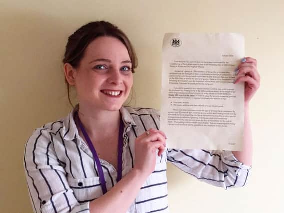 Carly Hain with the Royal Wedding invite she thought was a scam. PHOTO: SWNS