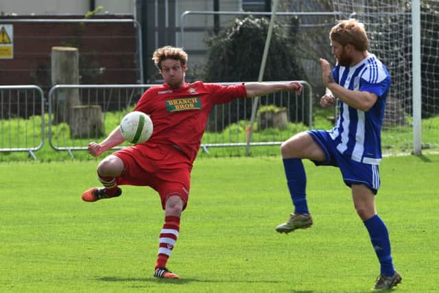 Wayne Morris (red) of Peterborough Northern Star in action at Eynesbury Rovers.Photo: Chantelle McDonald. @cmcdphotos.