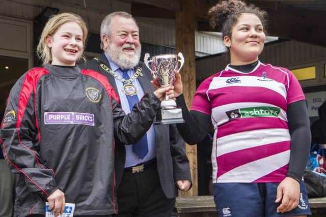 Peterborough mayor John Fox presents the trophy to joint winners Borough and Welwyn. The Peterborough captain (left) is Liberty Ashdown.
