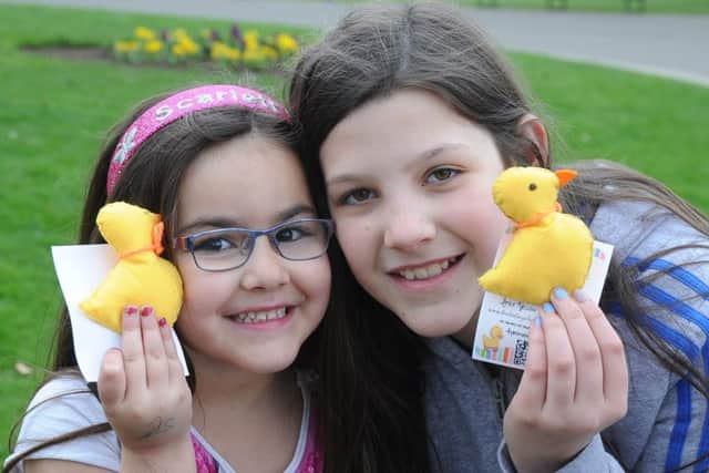 The Little Yellow Ducks Project duck give-away at Central Park. Skyler Graham and Lacey Carrington. EMN-180415-153618009