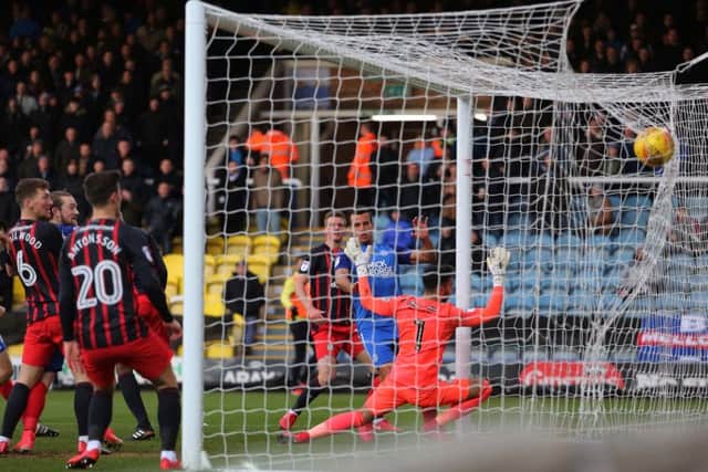 Steven Taylor (right) scores for Posh against Blackburn in December.