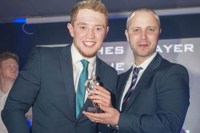 Glenn Billing (left) receives one of his four awards from Slava Koulikov.