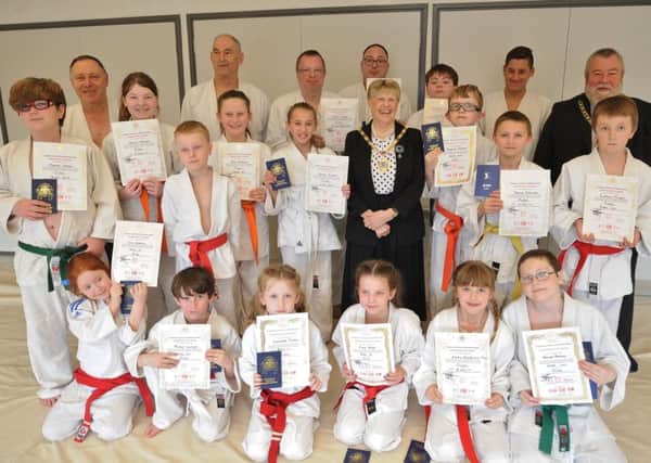 Allan Jones (back left) with students at his judo camp and the mayor and mayoress John and Judy Fox who presented the grading certificates.