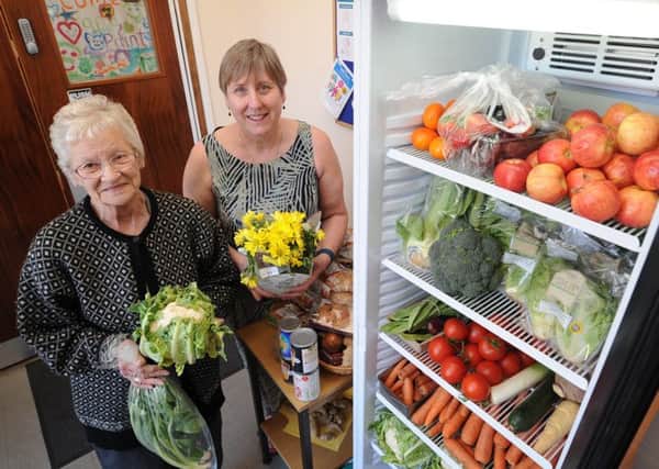 Revd. Carol Knight (right) with volunteer June McSparron and the free food fridge at the Open Door Baptist Church, Harris Street. EMN-180420-155444009