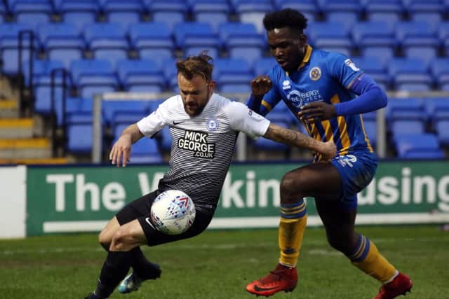 Danny Lloyd of Peterborough United in action with Aristote Nsiala of Shrewsbury Town. Photo: Joe Dent/theposh.com.