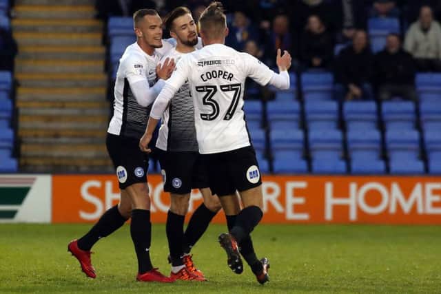 Posh man-of-the-match Gwion Edwards (centre) celebrates his goal at Shrewsbury. Photo: Joe Dent/theposh.com.