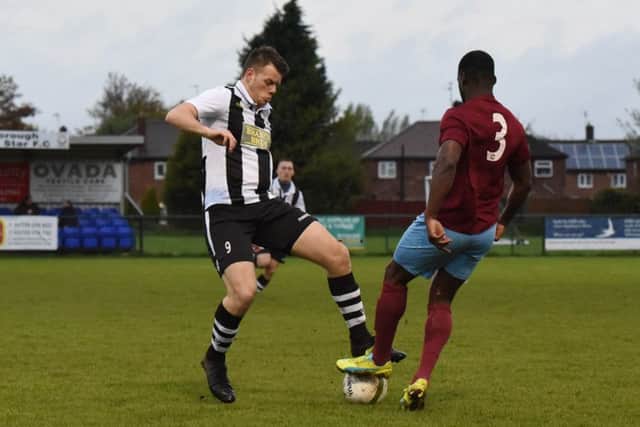 James Hill-Seekings (stripes) of Peterborough Northern Star in action against Deeping Rangers. Photo: Chantelle McDonald. @cmcdphotos.