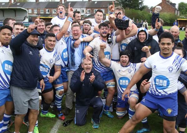 We are going up  . . . the Lions celebrate their promotion at Hull. Picture: Mick Sutterby