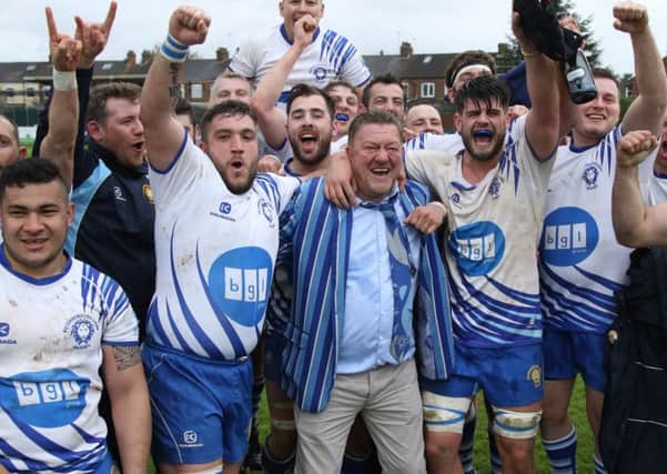 Chairman Andy Moore celebrates promotion with his players. Picture: Mick Sutterby