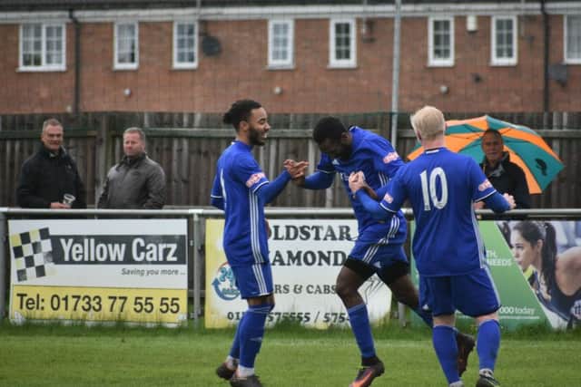 Avelino Vieira (centre) celebrates his goal for Peterborough Sports against Corby. Photo: James Richardson.