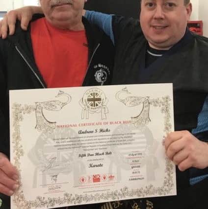 Andrew Hicks (right) received his 5th Dan black belt from Graham Smith.