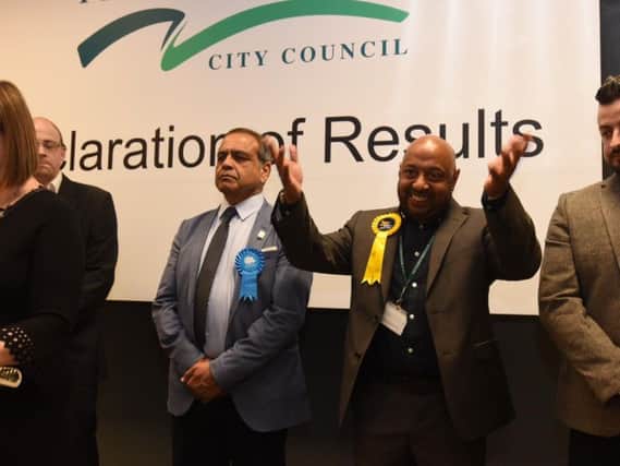 Asif Shaheed (second from right) celebrates his win