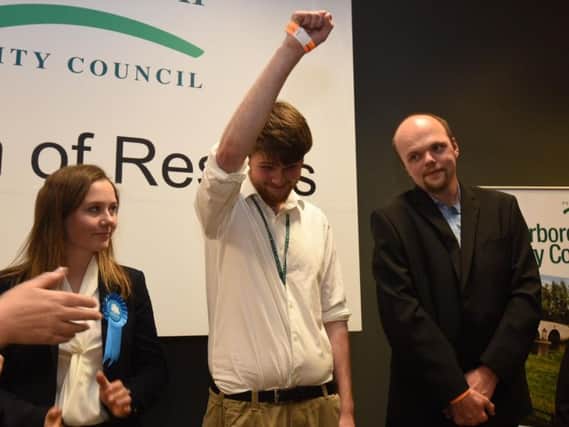 Andrew Bond with his arm raised after being announced as the winner