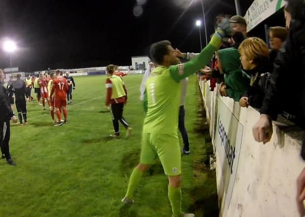 Stamford AFC goalkeeper Dan Haystead celebrates with the club's fans after the play-off semi-final win at Frickley.