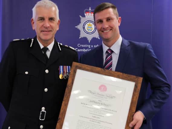 Stephen Jones receives his award from Chief Constable Alec Wood