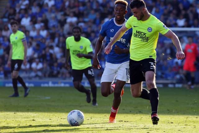 Andrew Hughes of Peterborough United in action with Jamal Lowe of Portsmouth. Photo: Joe Dent/theposh.com.