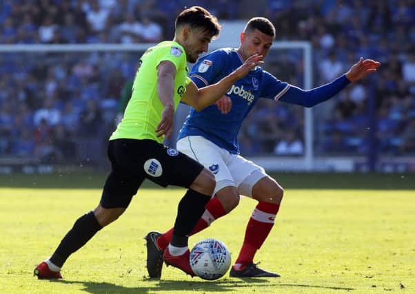 Liam Shephard of Peterborough United in action with Stuart O'Keefe of Portsmouth. Photo: Joe Dent/theposh.com.