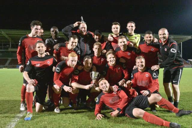 Netherton United pose for the camera with their Northants County Cup. Photo: James Richardson.