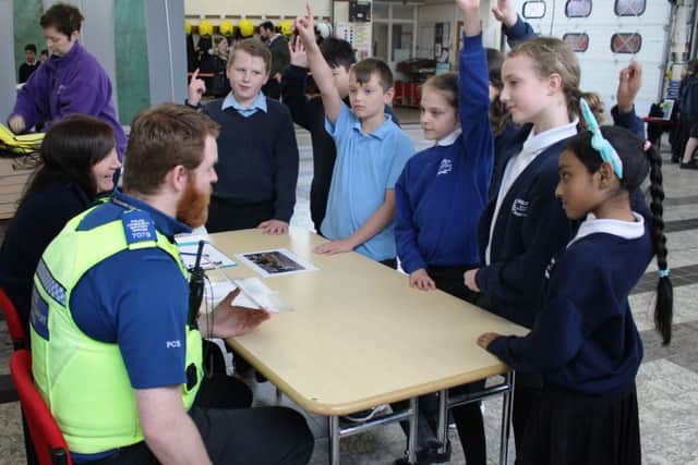 PCSO Thomas Horwood and Fenland District Councils community projects officer Rosie Cooke ask pupils what they should do if they spot antisocial behaviour