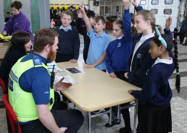 PCSO Thomas Horwood and Fenland District Councils community projects officer Rosie Cooke ask pupils what they should do if they spot antisocial behaviour