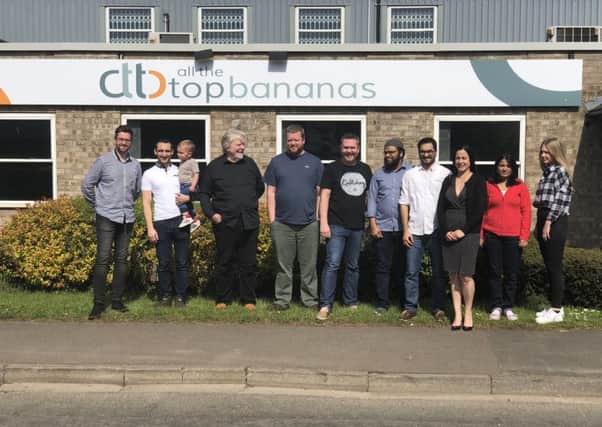 The staff of AllTheTopBananas outside the firms new base.