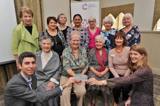 Prof. Nitzan Rosenfeld from Addenbrooke's cancer research receives a cheque from  Miranda Rock (front right) on behalf of the Burghley Park and Peterborough Ladies for Cancer Research UK members at the William Cecil Hotel, Stamford. EMN-171024-184925009