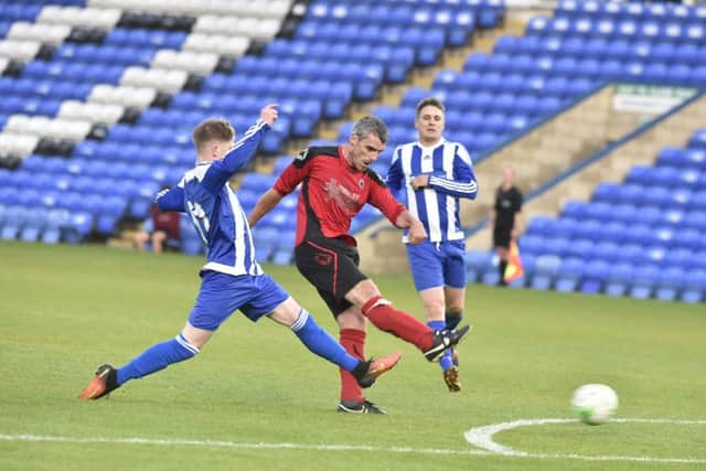 Mark Baines of Netherton United shoots at the Moulron Harrox goal. Photo: David Lowndes.