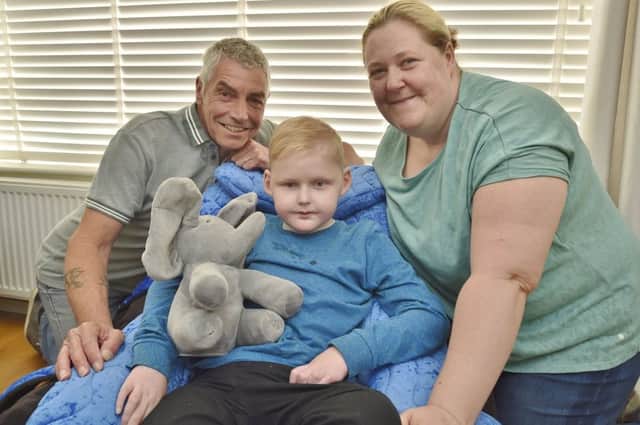 Charity runner  Barry Long with Brody Kelly (8) and his mum Sharon Kelly at their home at Thorney. EMN-180519-081608009