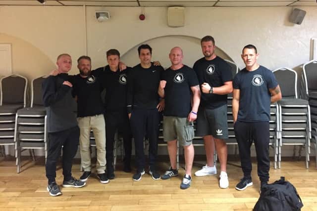 Whittlesey ABC coaches pictured with senior boxers Tom Middleton (left) and Salvatorie Genovese (centre).